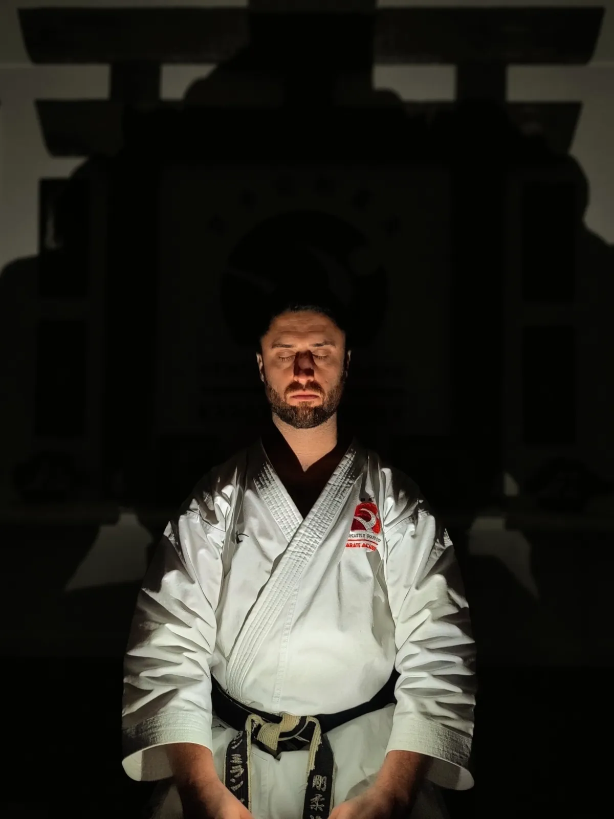 Roaring Sensei in his gi and black belt at the dojo — 5th Dan black belt karate instructor